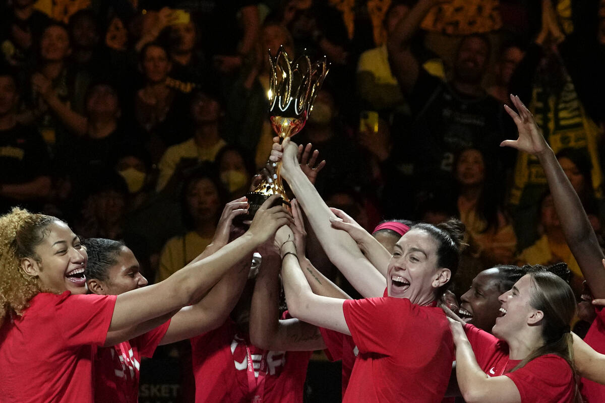 Players from the United States celebrate with with their trophy after defeating China in their ...