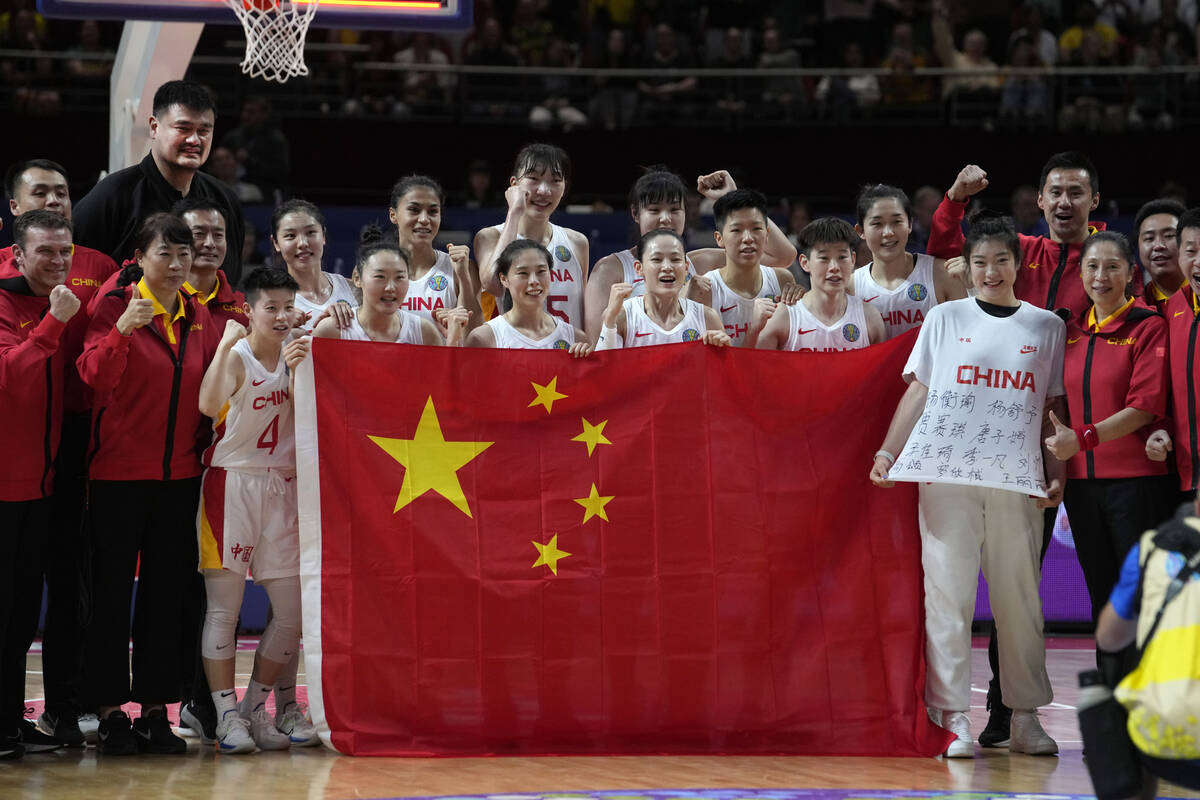 Players from China celebrate with former NBA start Yao Ming, fourth left, after winning silver ...