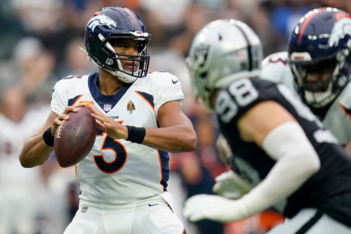 Denver Broncos quarterback Russell Wilson (3) drops back to pass as Las Vegas Raiders defensive ...