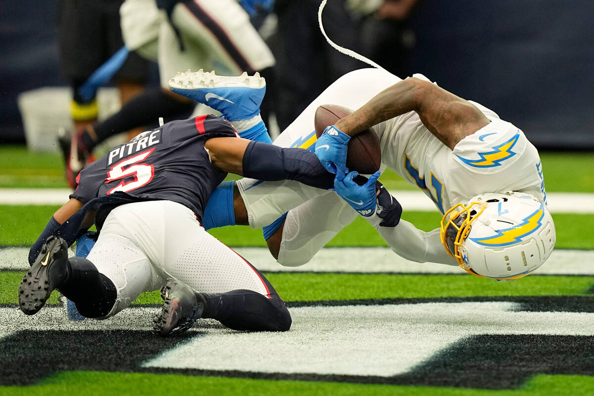 Los Angeles Chargers tight end Gerald Everett (7) pulls in a pass over Houston Texans safety Ja ...