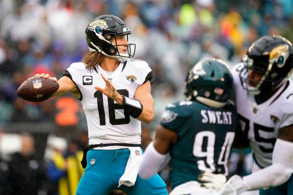 Jacksonville Jaguars' Trevor Lawrence looks to pass during the first half of an NFL football ga ...