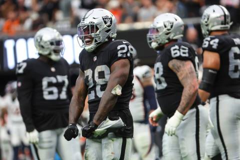 Raiders running back Josh Jacobs (28) reacts after his touchdown against the Denver Broncos dur ...