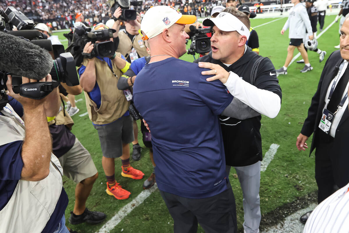 Raiders head coach Josh McDaniels greets Denver Broncos head coach Nathaniel Hackett after McDa ...