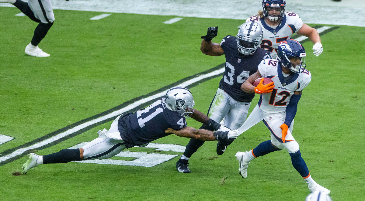 Raiders safety Matthias Farley (41) attempts to tackle Denver Broncos wide receiver Montrell Wa ...