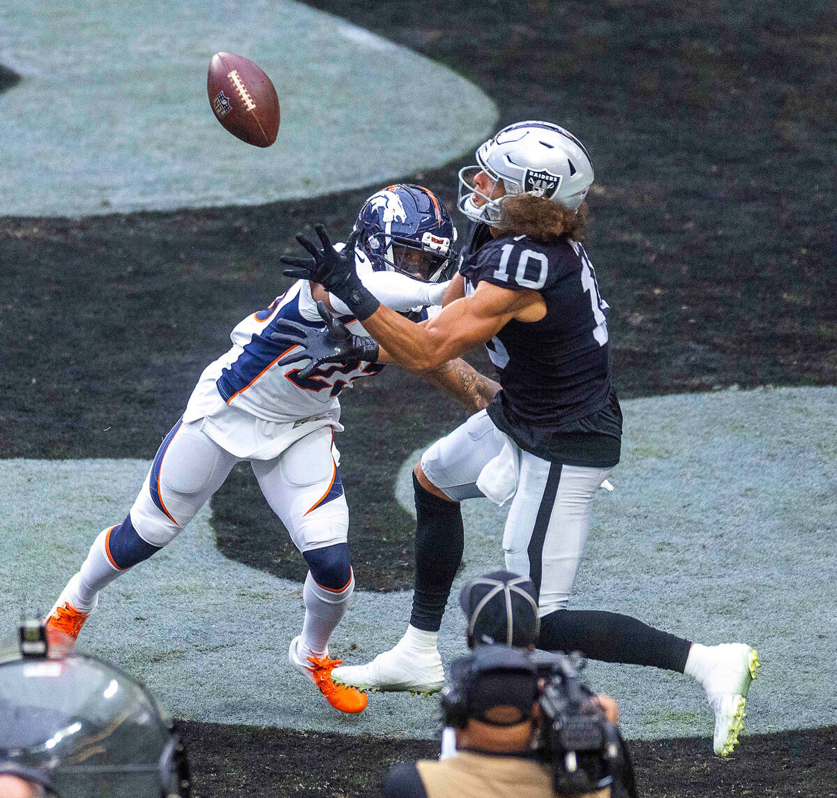 Raiders wide receiver Mack Hollins (10) looks in a possible touchdown pass as Denver Broncos co ...