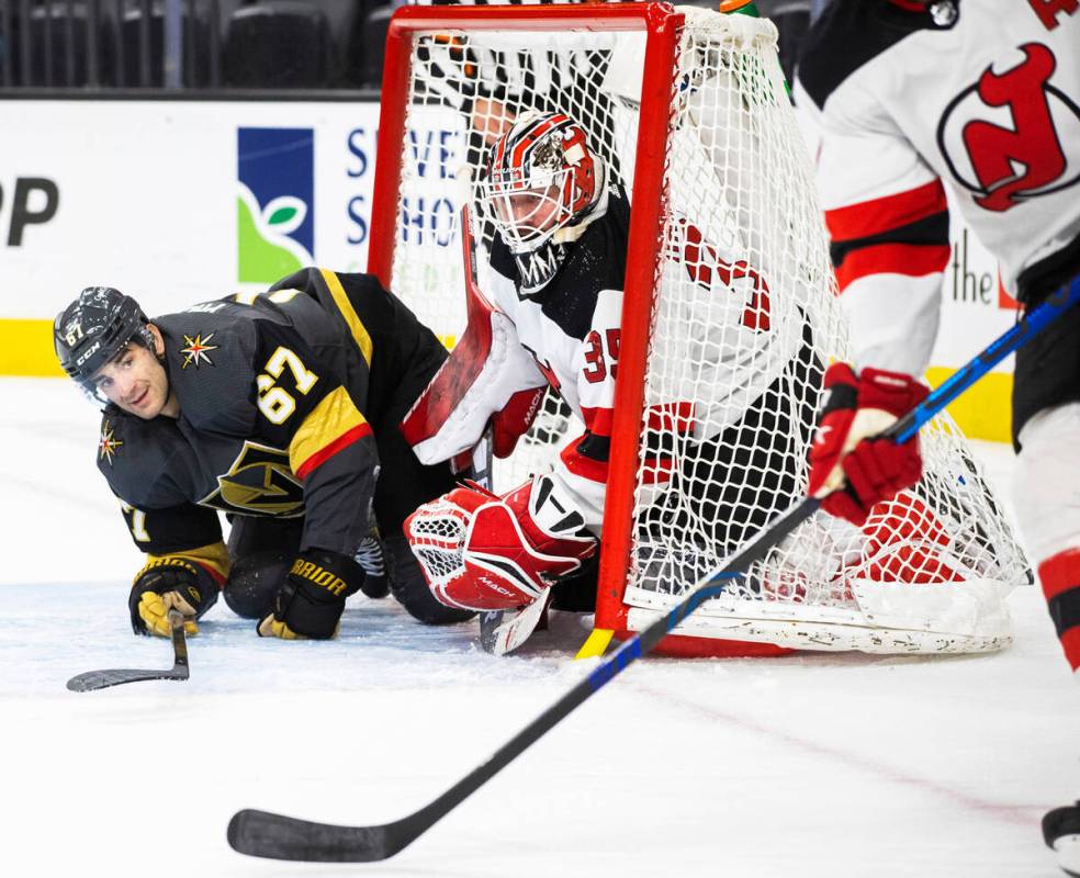 Golden Knights left wing Max Pacioretty (67) collides with New Jersey Devils goaltender Andrew ...