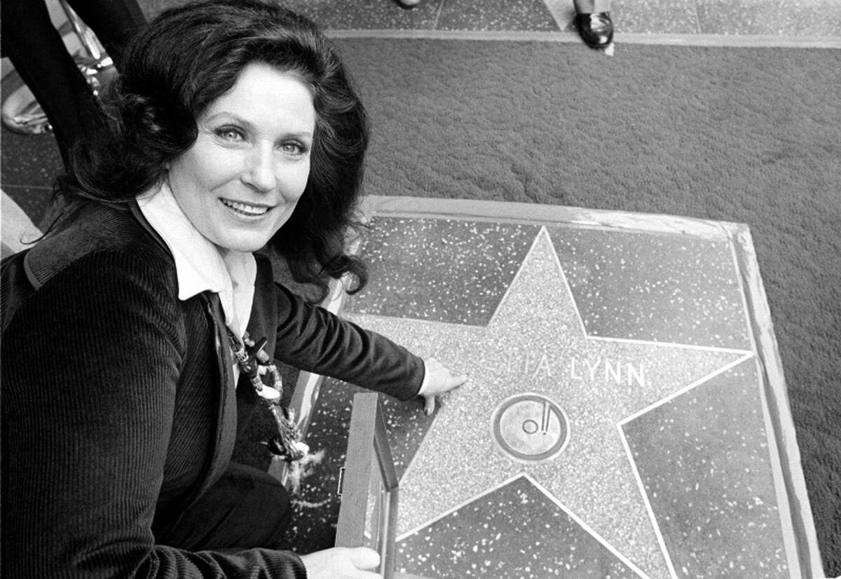 FILE - Country music singer Loretta Lynn points to her Hollywood Walk of Fame star during induc ...
