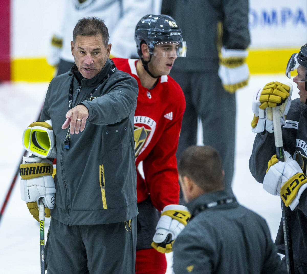 Golden Knights Head Coach Bruce Cassidy, left, addresses his players during practice at City Na ...