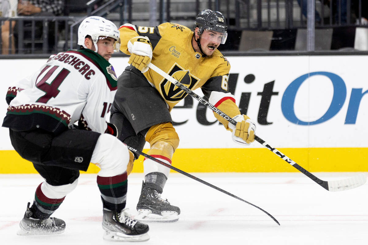 Golden Knights defenseman Zack Hayes (65) scores a goal while Coyotes defenseman Shayne Gostisb ...