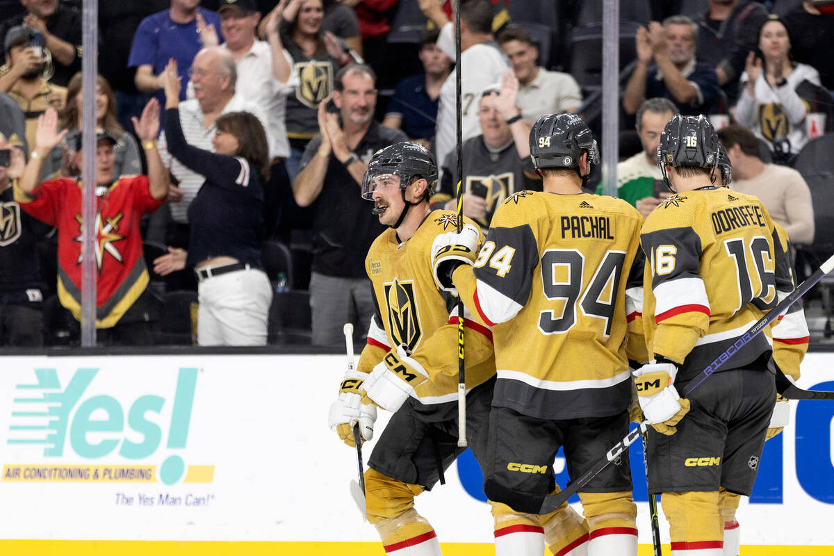 Golden Knights defenseman Zack Hayes (65), defenseman Brayden Pachal (94) and left wing Pavel D ...