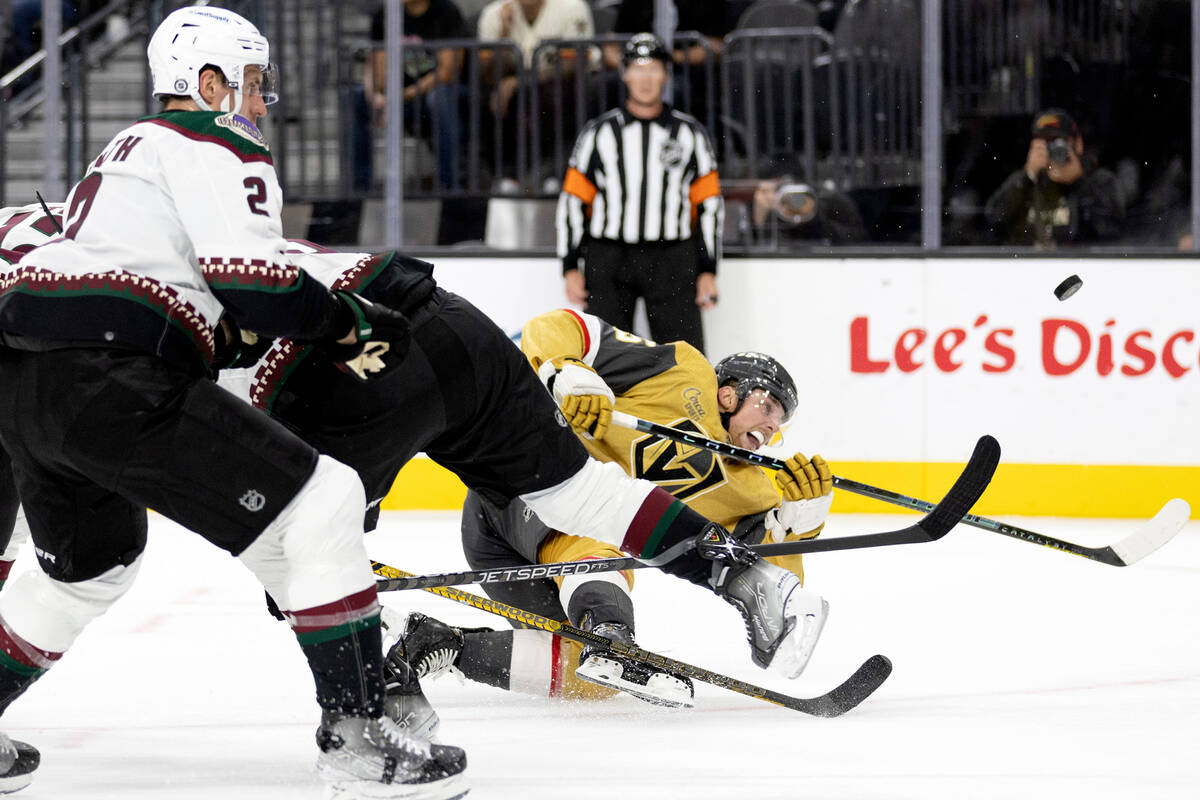 Golden Knights center Jake Leschyshyn (15) falls to the ice while taking a shot on goal while C ...