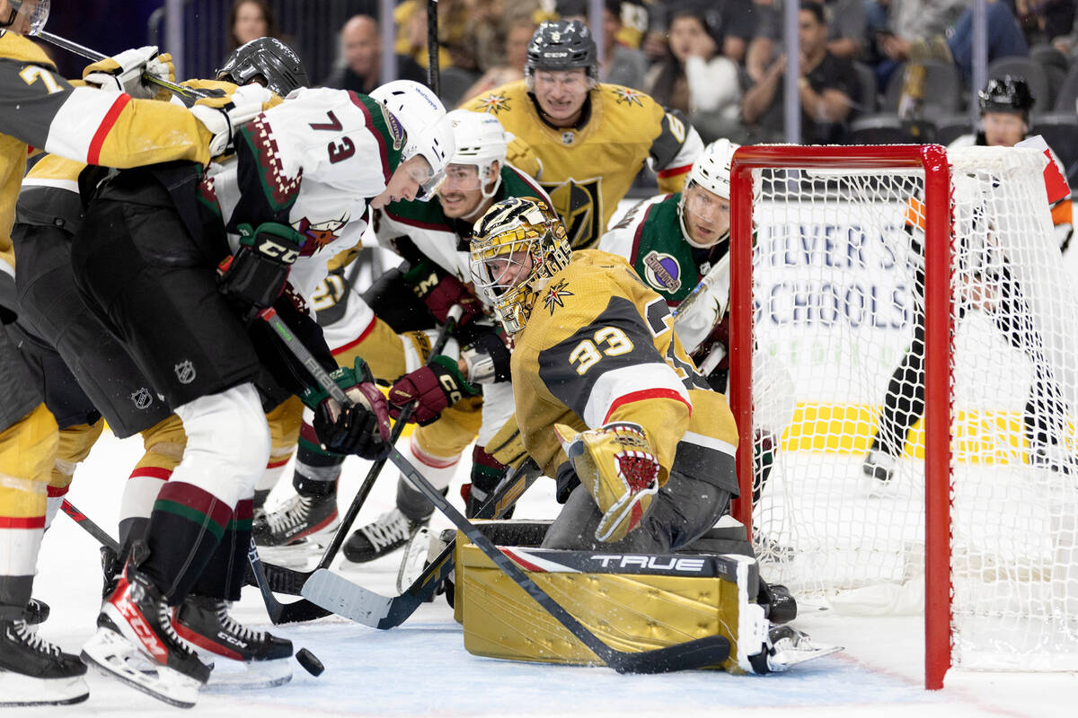 Coyotes forward Jan Jenik (73) fights to get the puck in the net while Golden Knights goaltende ...