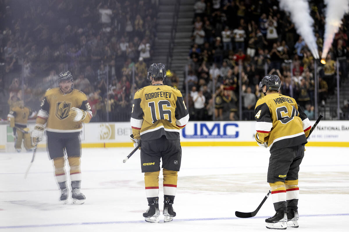 Golden Knights defenseman Zack Hayes (65) and center Sakari Manninen (64) skate to the bench wi ...