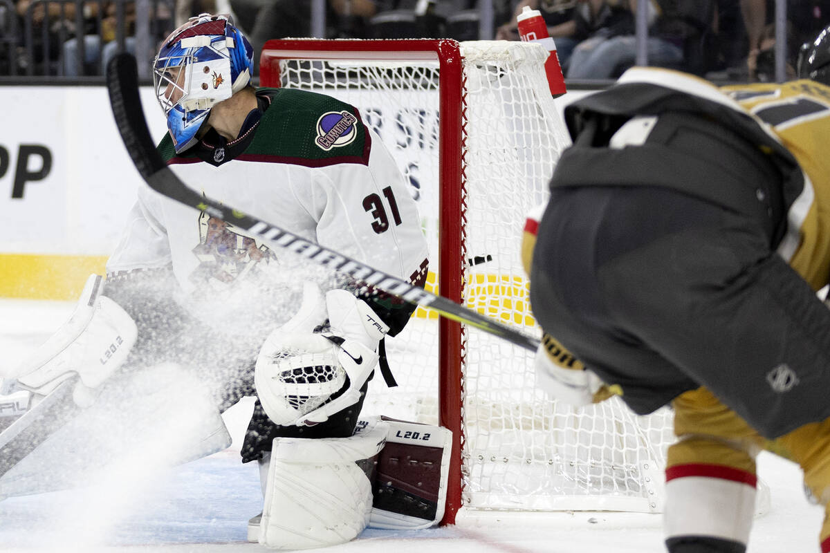 Golden Knights center William Karlsson, right, scores against Coyotes goaltender Jonas Johansso ...