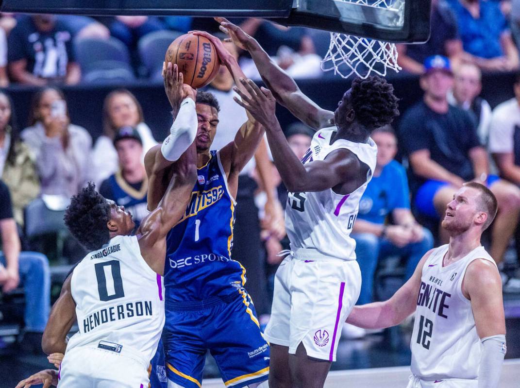 NBA G League Ignite guard Scoot Henderson (0) a hand on the ball Metropolitans 92 center Victor ...