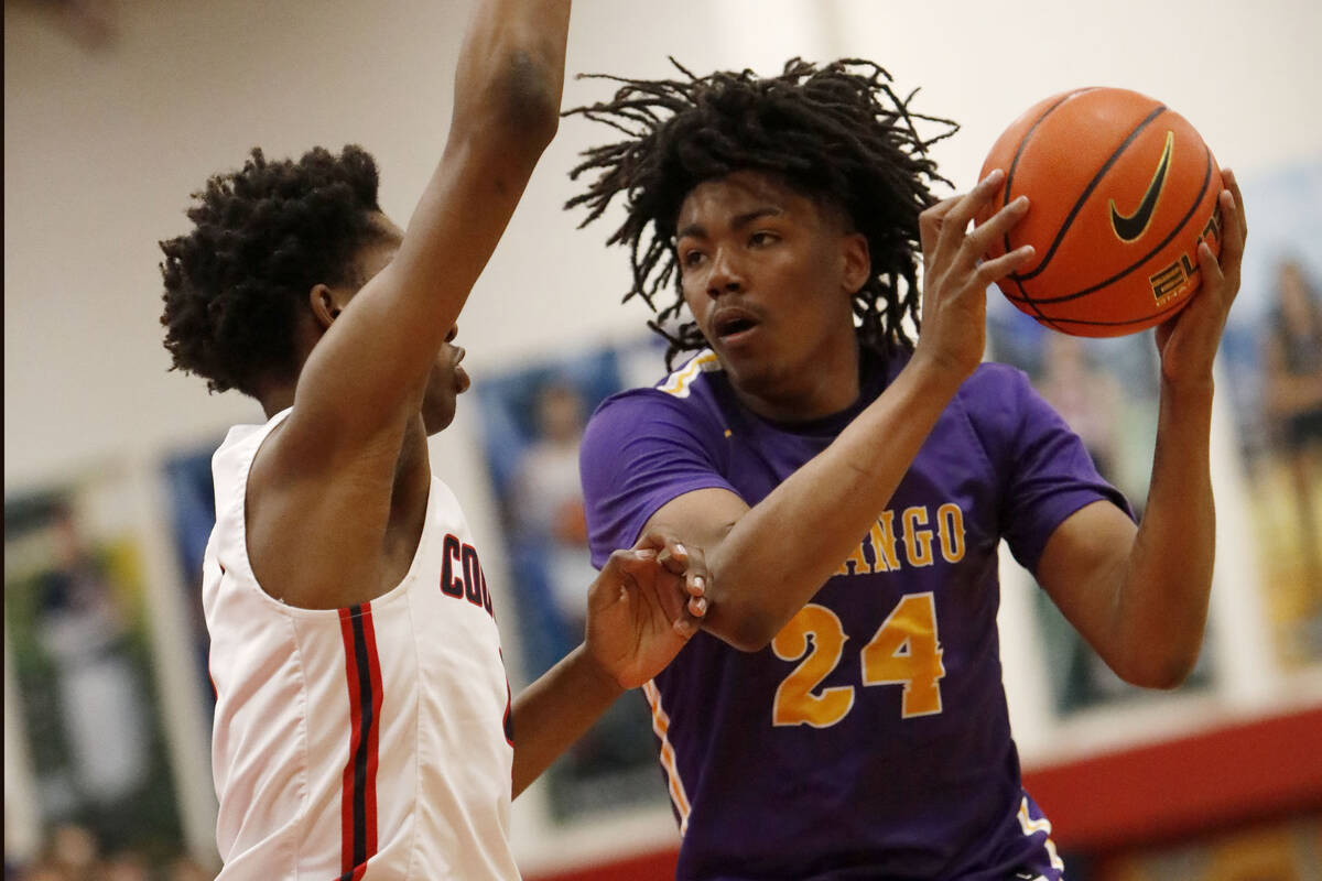 Durango High School's Taj Degourville (24) keeps a ball away from Coronado High School's Ron Jo ...