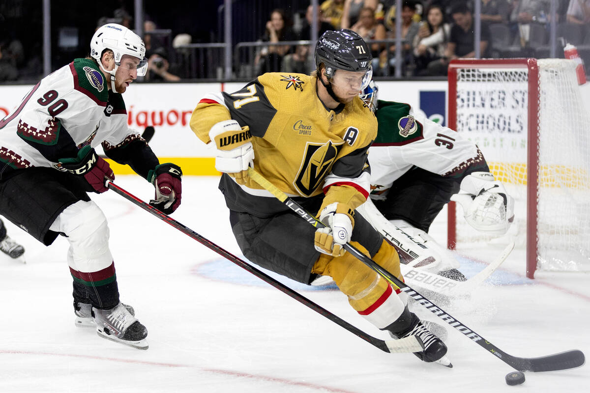 Golden Knights center William Karlsson (71) dangles the puck while Coyotes defenseman J.J. Mose ...