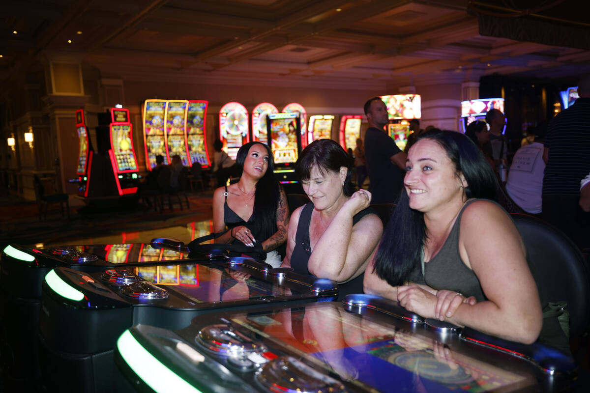 Stacey McLachlan, right, of Vancouver plays an electronic table game at the Bellagio, Thursday, ...