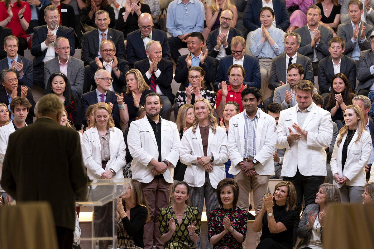 UNLV medical students stand for applause as Gov. Steve Sisolak recognizes their commitment to p ...