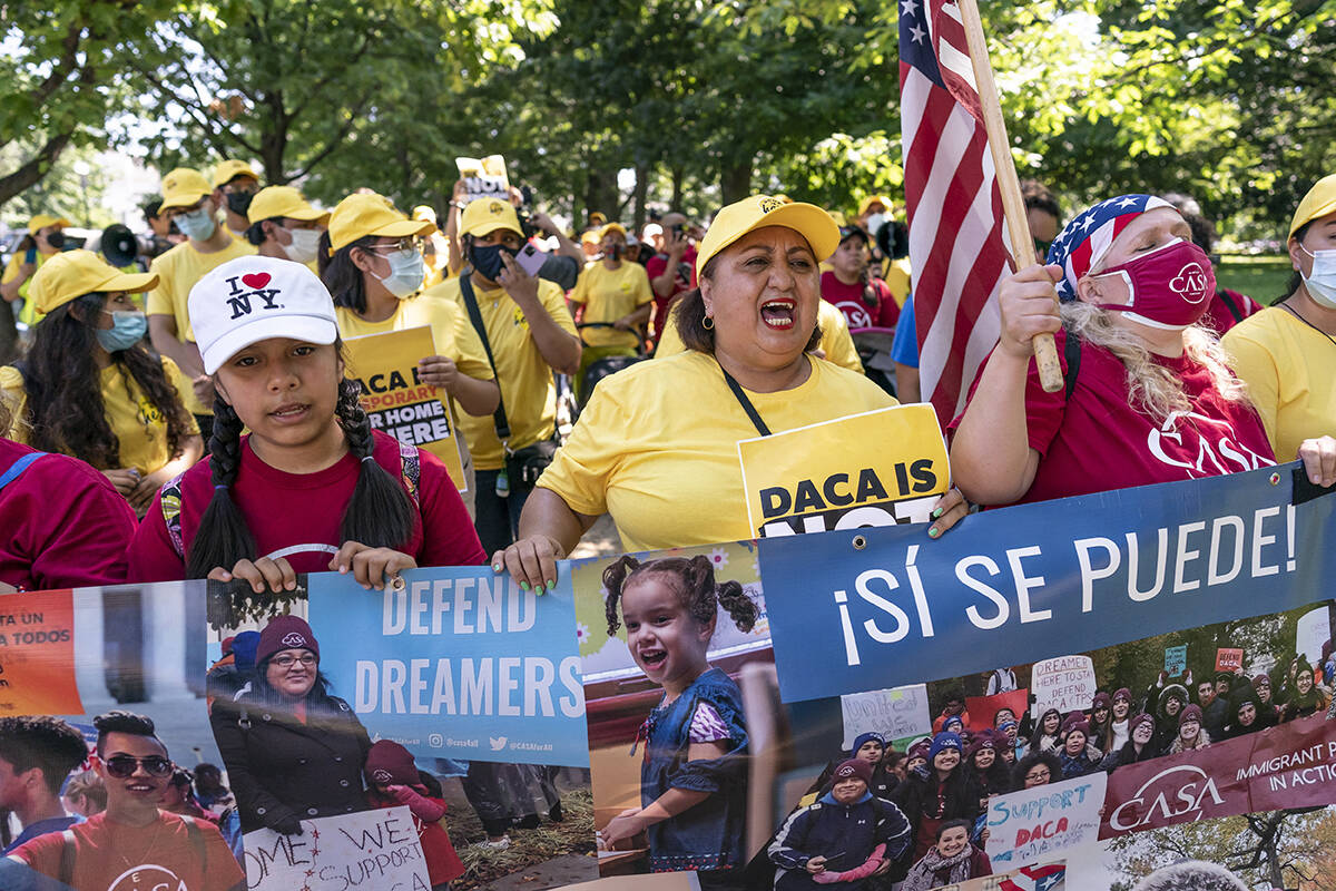 Ingrid Vaca, center, a native of Bolivia, helps to energize activists to rally in support of th ...