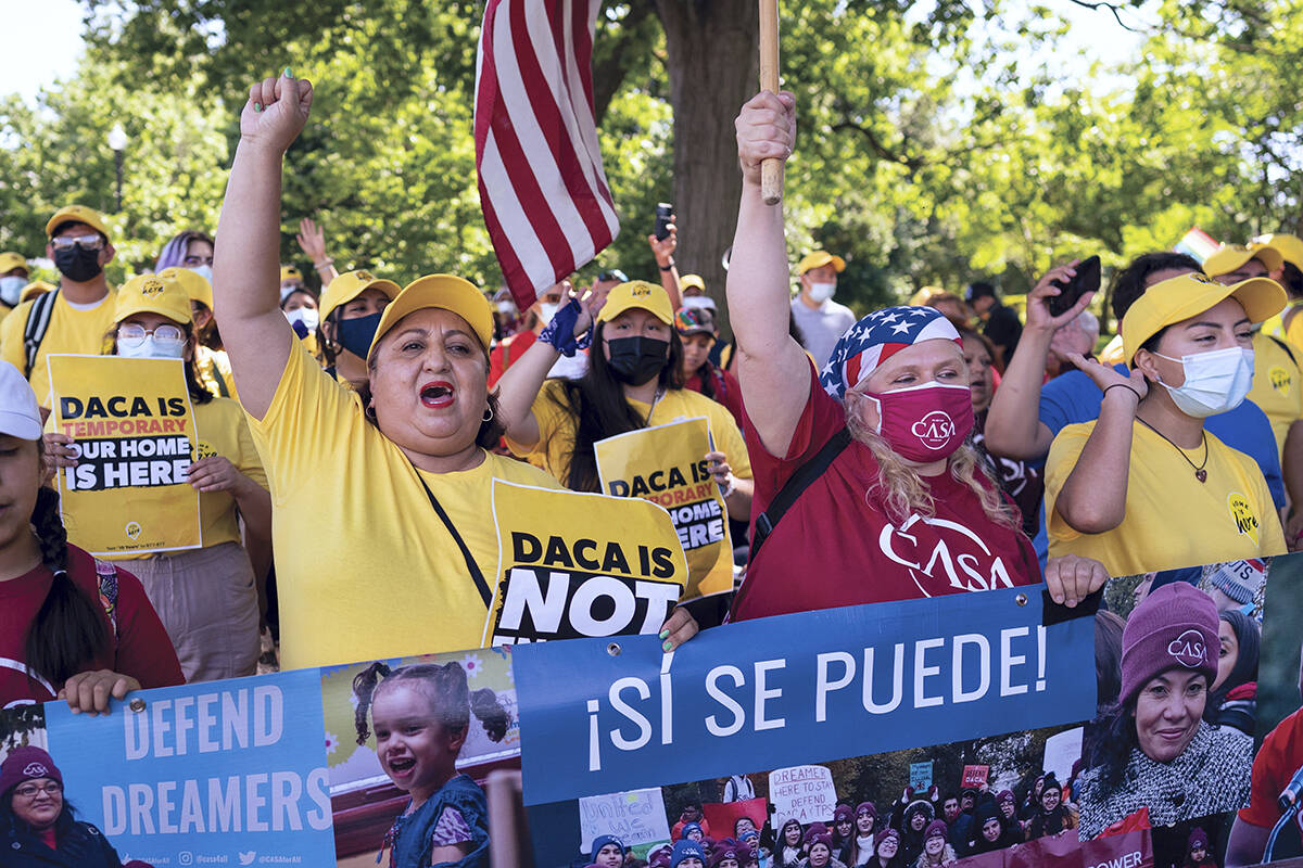 Ingrid Vaca, left, a native of Bolivia, helps to energize activists to rally in support of the ...