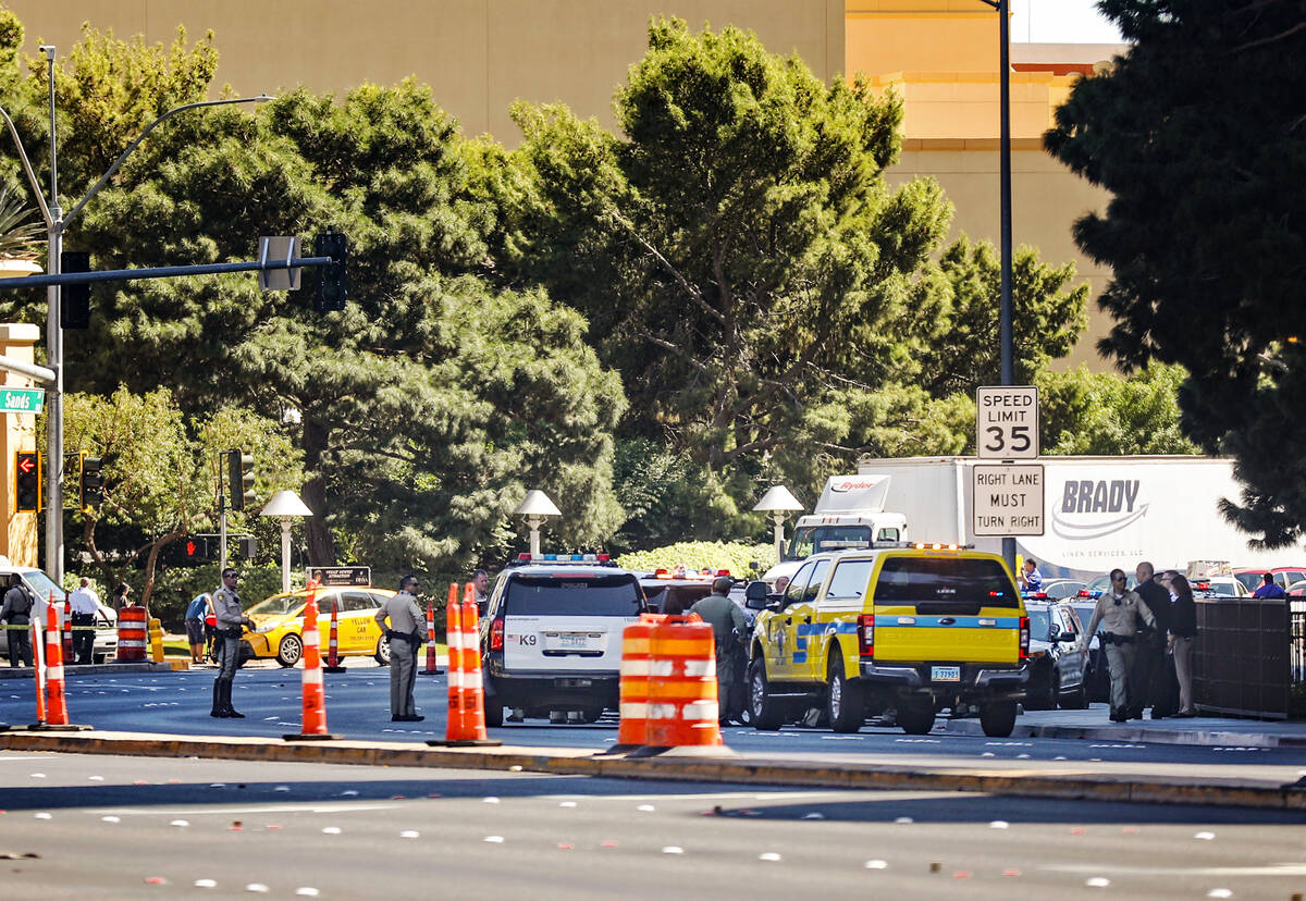 Police at the scene where multiple people were stabbed in front of a Strip casino in Las Vegas, ...