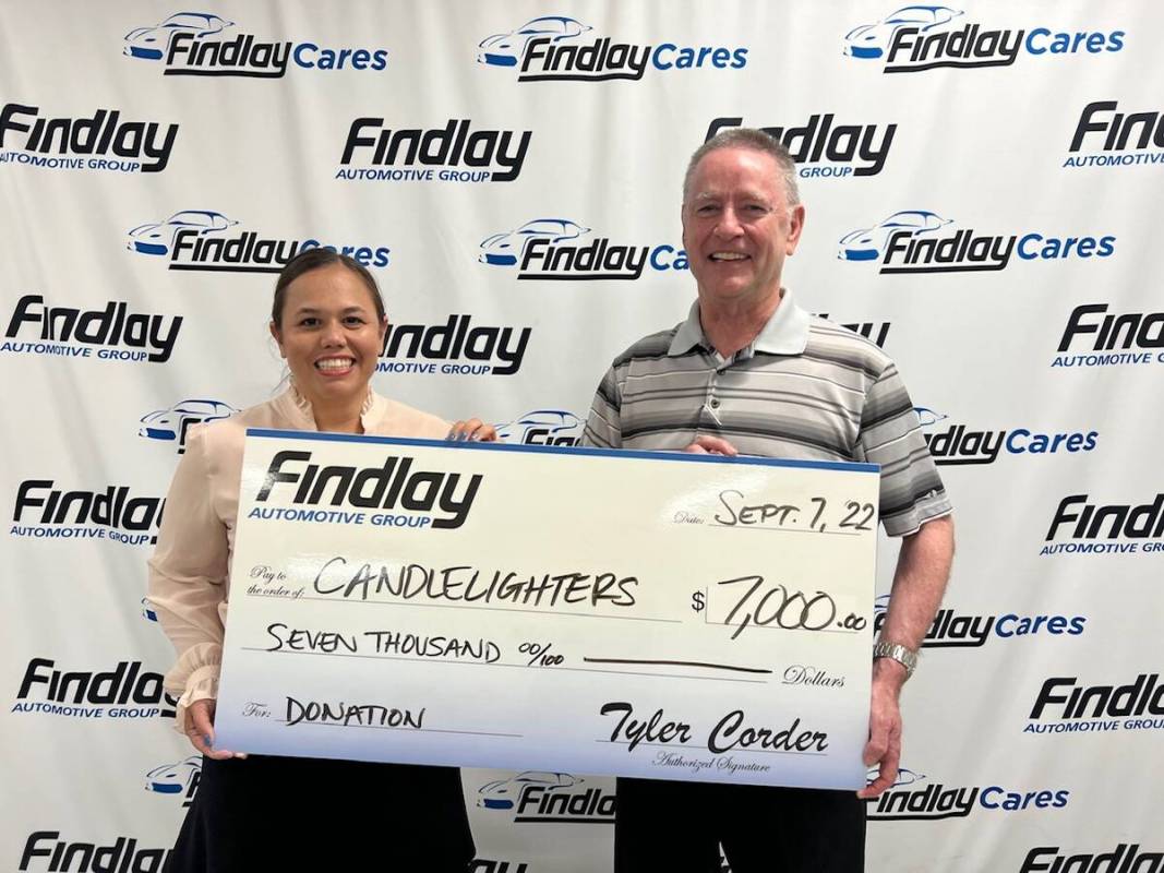Findlay Automotive Group CFO Tyler Corder, right, presents a check for $7,000 to Kimberly Kindi ...