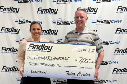 Findlay Automotive Group CFO Tyler Corder, right, presents a check for $7,000 to Kimberly Kindi ...