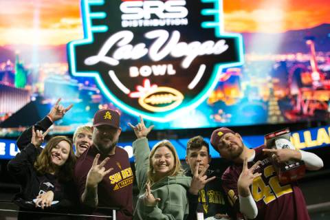 Arizona State Sun Devils fans pose for photos before the Las Vegas Bowl NCAA college football g ...