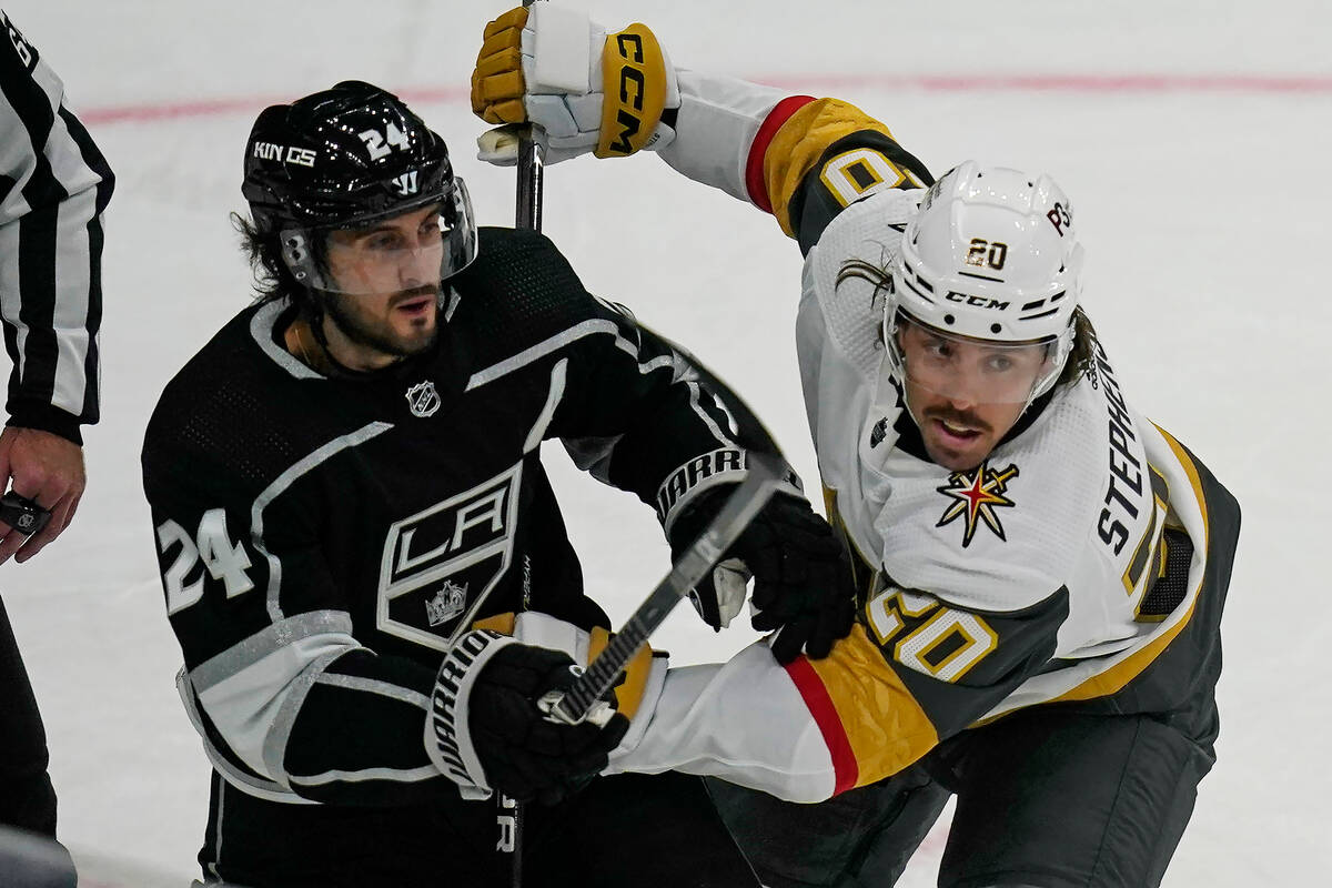 Vegas Golden Knights center Chandler Stephenson (20) battles with Los Angeles Kings center Phil ...