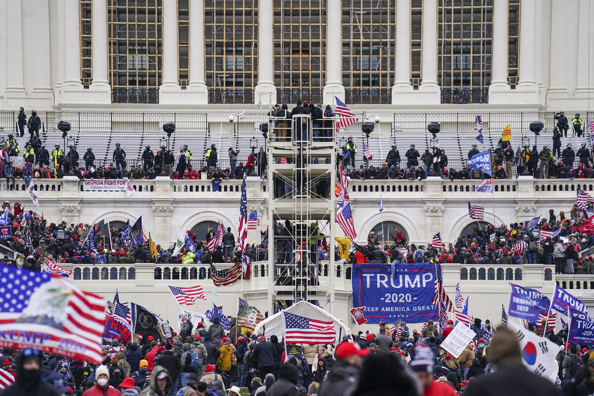 FILE - Insurrectionists loyal to President Donald Trump breach the Capitol in Washington, Jan. ...