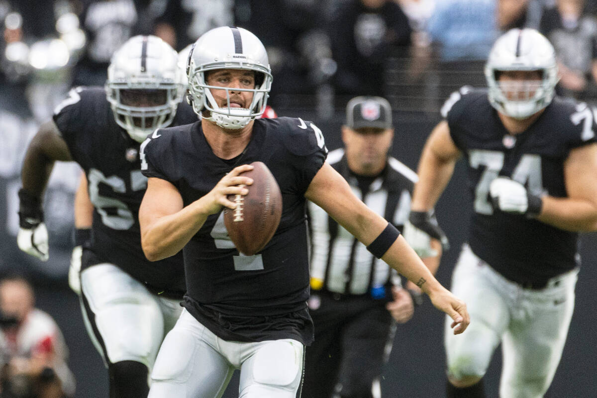 Raiders quarterback Derek Carr (4) runs with the ball during the first half of an NFL game agai ...