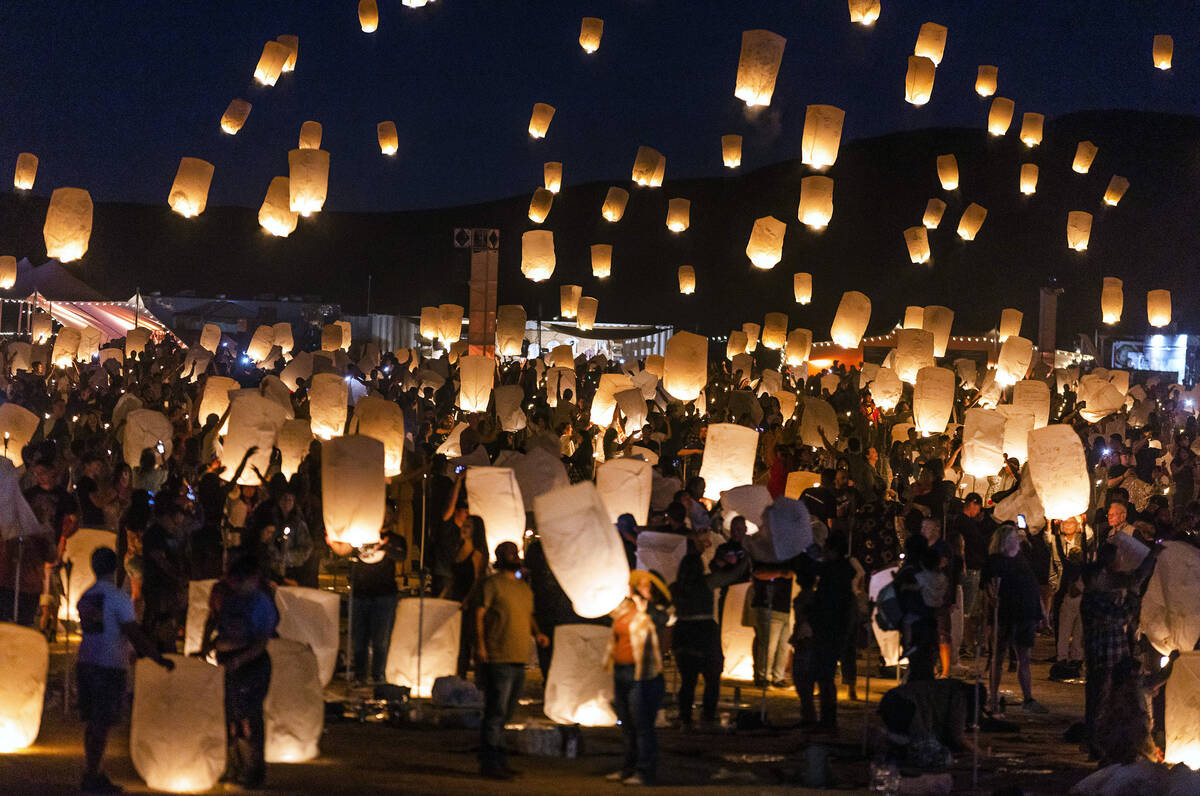 People release lanterns as a group during the RiSE Lantern Fest at the Jean Dry Lake Bed on Fri ...