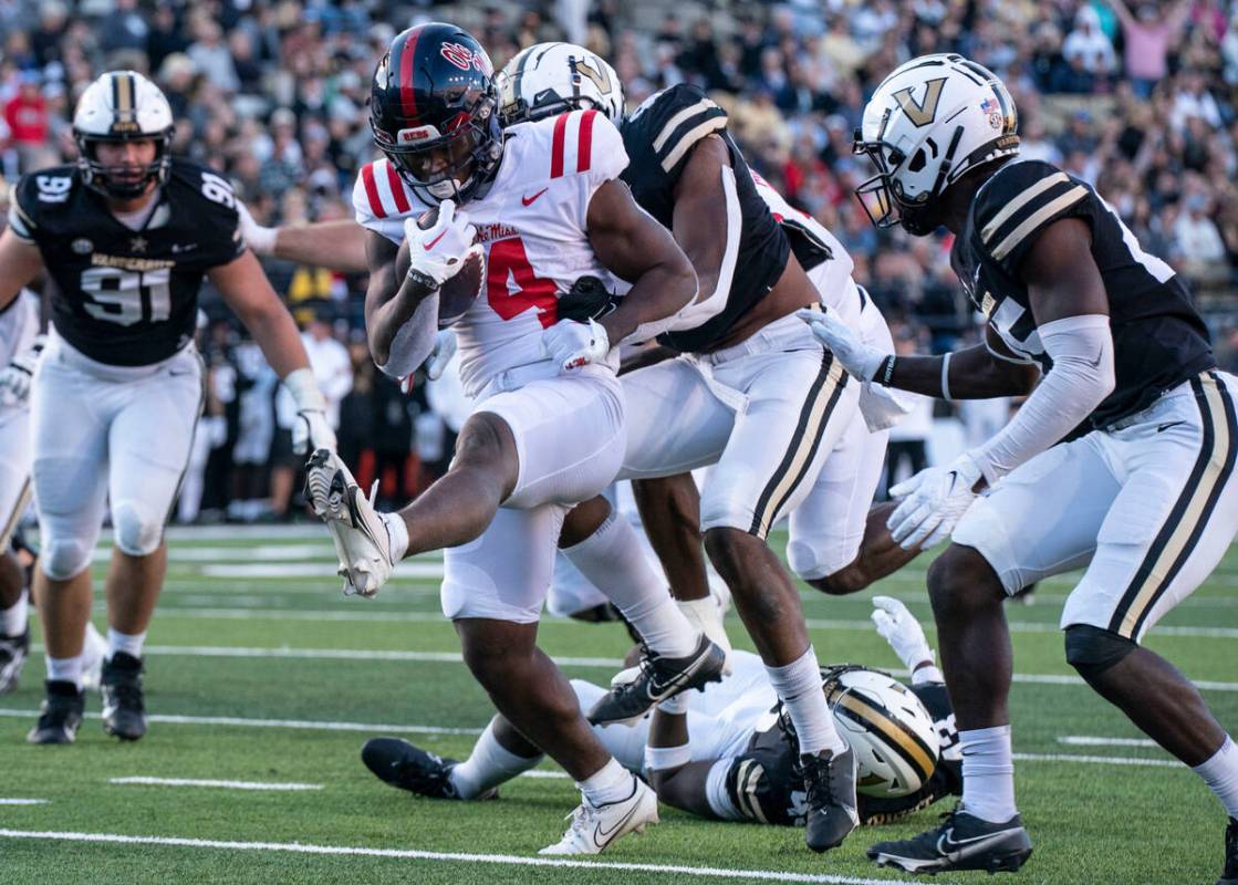 Mississippi running back Quinshon Judkins (4) high-steps into the end zone for a touchdown past ...