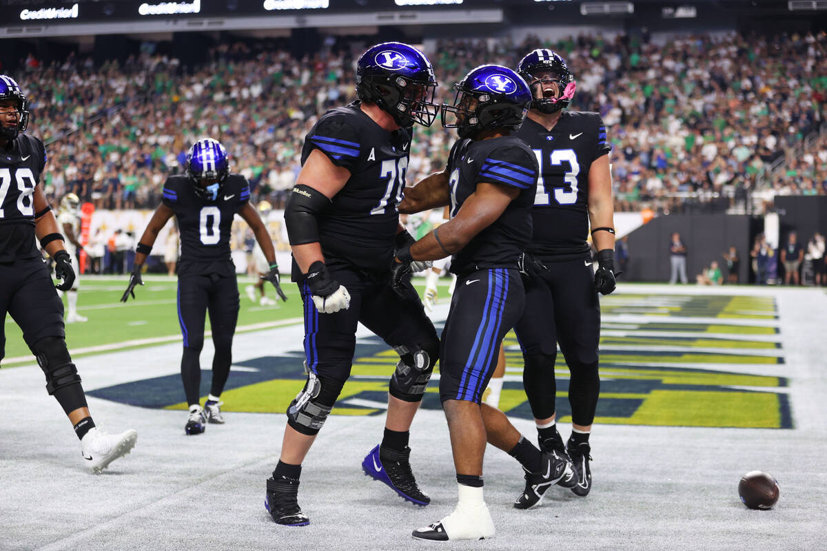 Brigham Young Cougars running back Christopher Brooks (2) celebrates his touchdown run with off ...