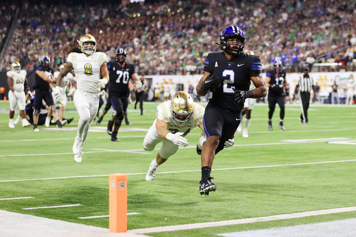 Brigham Young Cougars running back Christopher Brooks (2) runs for a touchdown as he is tackled ...