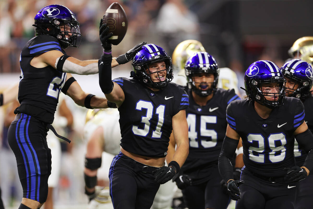 Brigham Young Cougars linebacker Max Tooley (31) celebrates his interceptions against the Notre ...