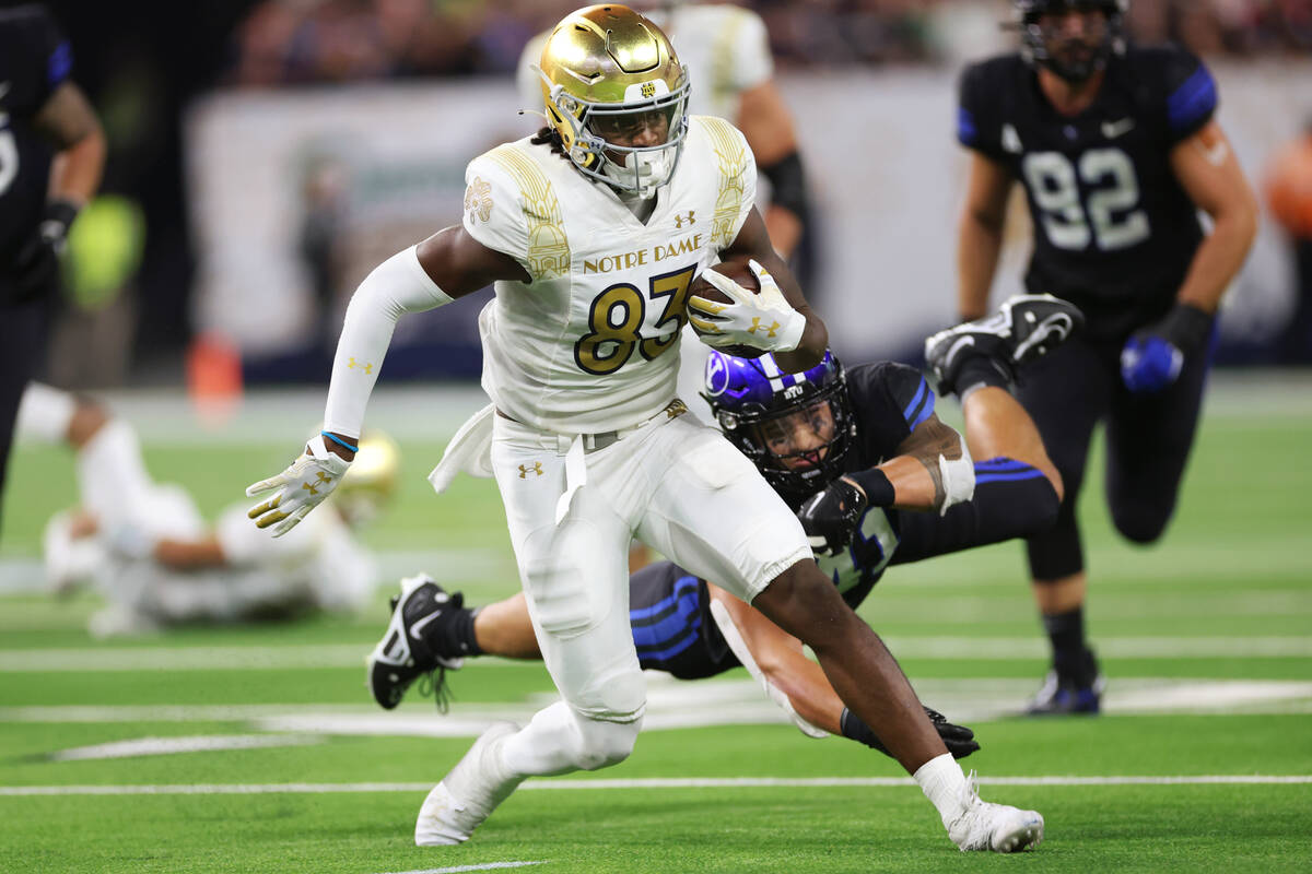 Notre Dame Fighting Irish wide receiver Jayden Thomas (83) runs the ball after missing a tackle ...