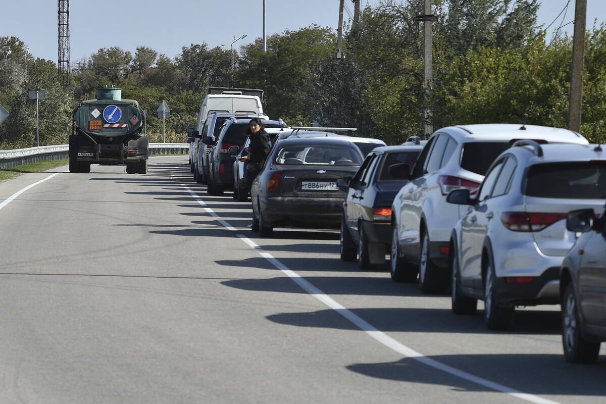 Cars queue for the ferry connecting Crimean peninsula and Russia at the Kerch Strait, in Kerch, ...