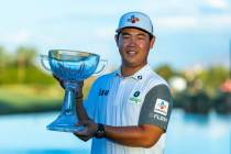 Tom Kim holds up his winning trophy during the final day of play in the Shriners Children's Ope ...