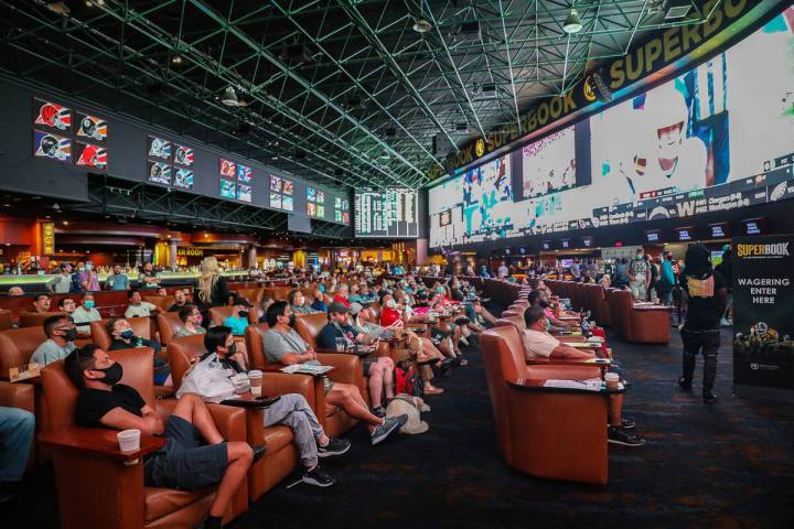 A packed house watches the screens at the Sports Book at Westgate in Las Vegas, Sunday, Sept. 1 ...