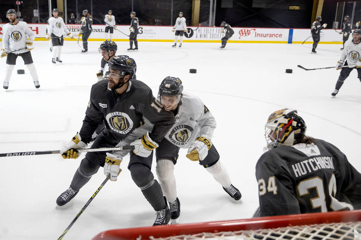 Golden Knights center Nicolas Roy (10) and right wing Jonas Rondbjerg (46) defend each other wh ...