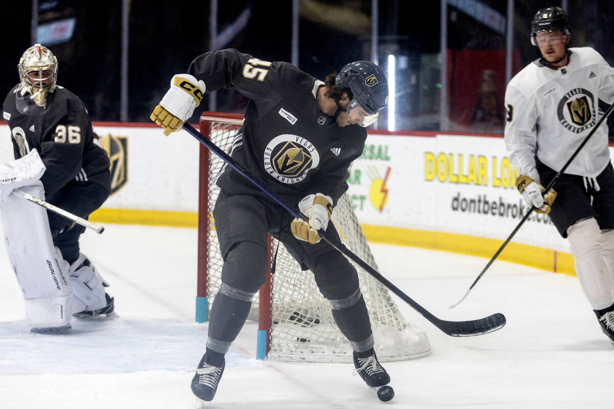 Golden Knights defenseman Jake Bischoff (45) receives the puck flanked by goaltender Logan Thom ...