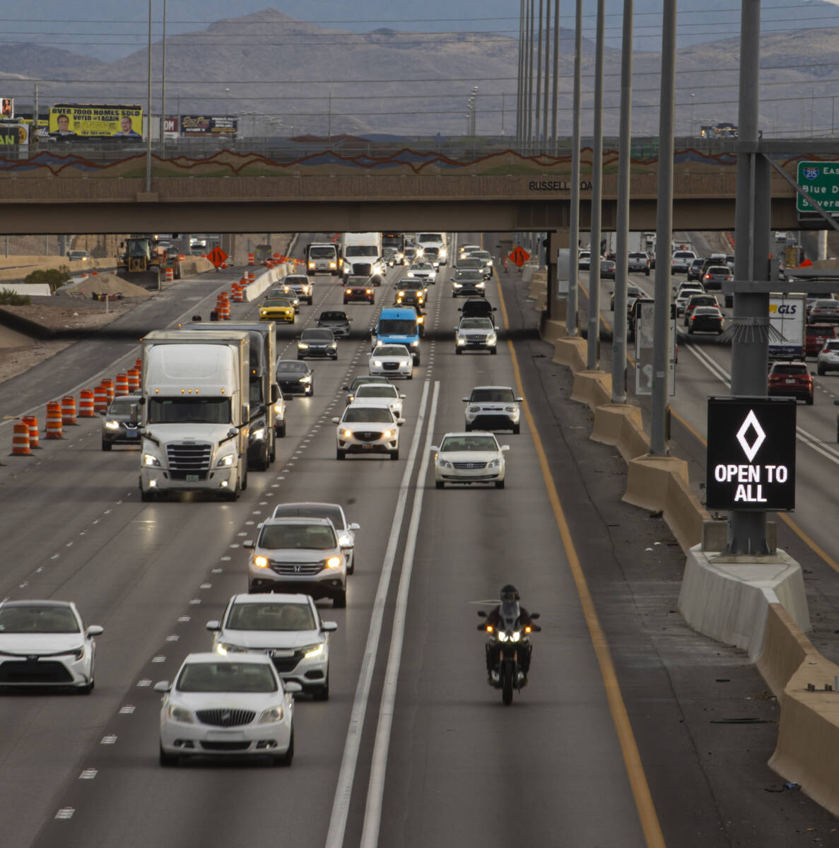 An HOV lane sign denotes that the lane is "open to all" as part of a pilot transporta ...