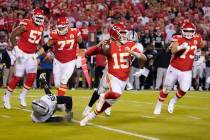 Kansas City Chiefs quarterback Patrick Mahomes (15) throws as he scrambles during the first hal ...
