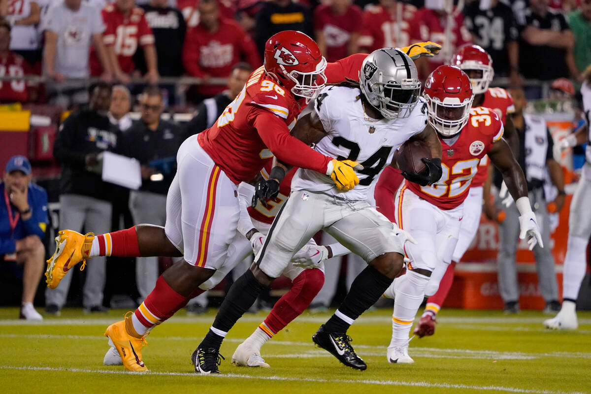 Las Vegas Raiders running back Brandon Bolden (34) runs with the ball as Kansas City Chiefs def ...