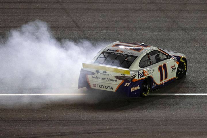 Denny Hamlin celebrates by spinning his number 11 after he won the 4th Annual South Point 400 a ...