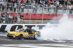 Christopher Bell (20) does a burnout after winning a NASCAR Cup Series auto race at Charlotte M ...