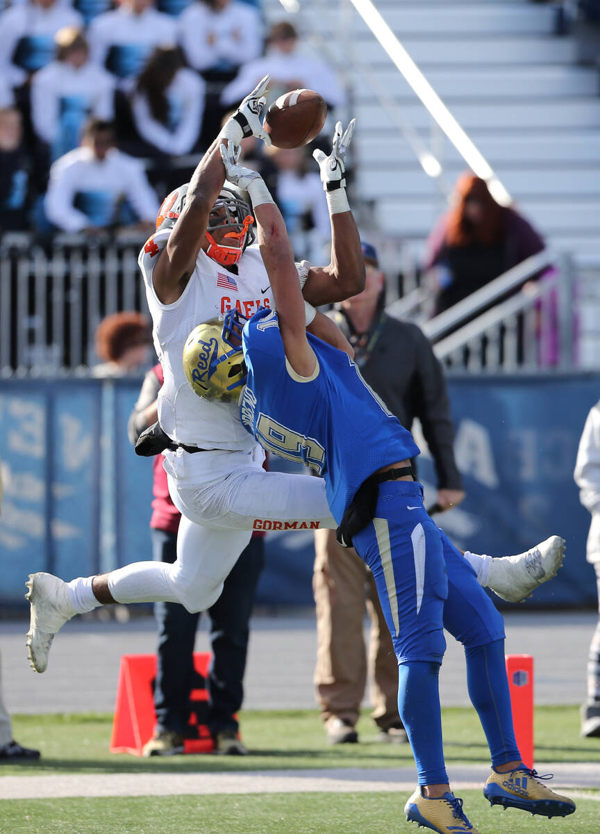 Bishop Gorman's Cedric Tillman tries to make a reception in the end zone against ReedÕs George ...