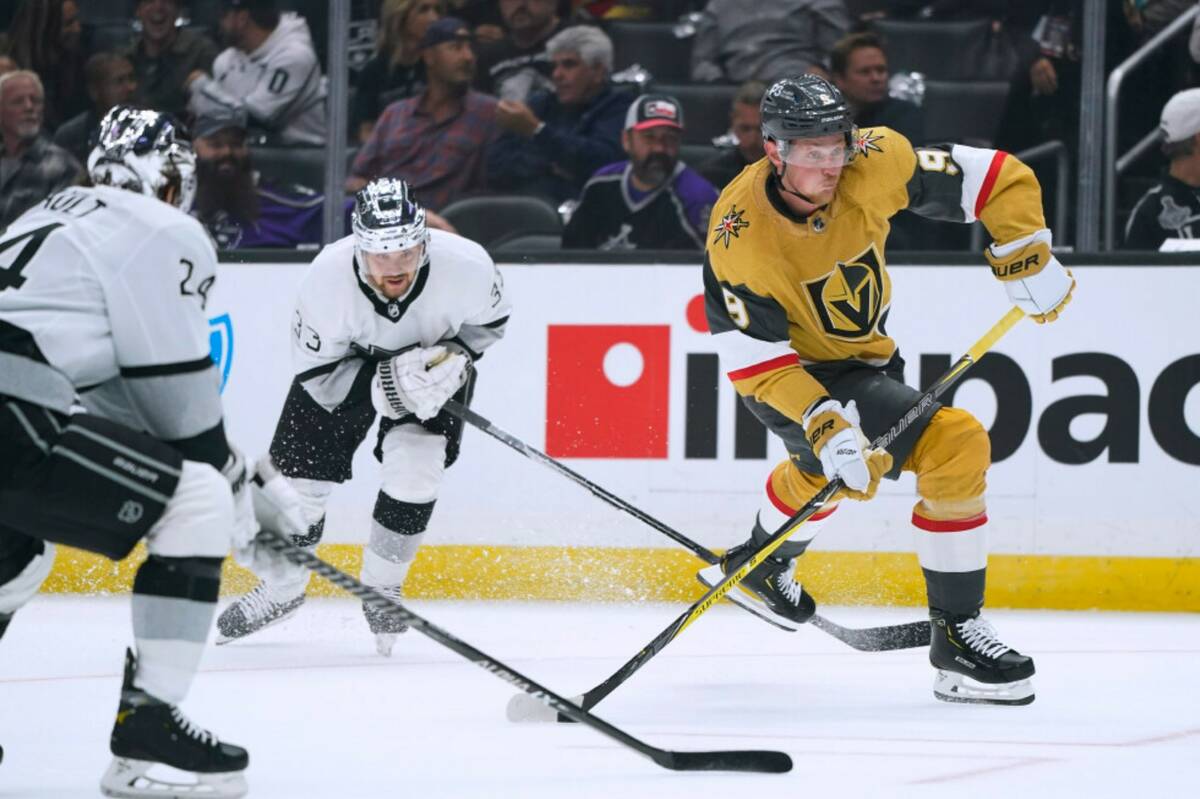 Vegas Golden Knights' Jack Eichel, right, shoots under pressure from Los Angeles Kings' Phillip ...